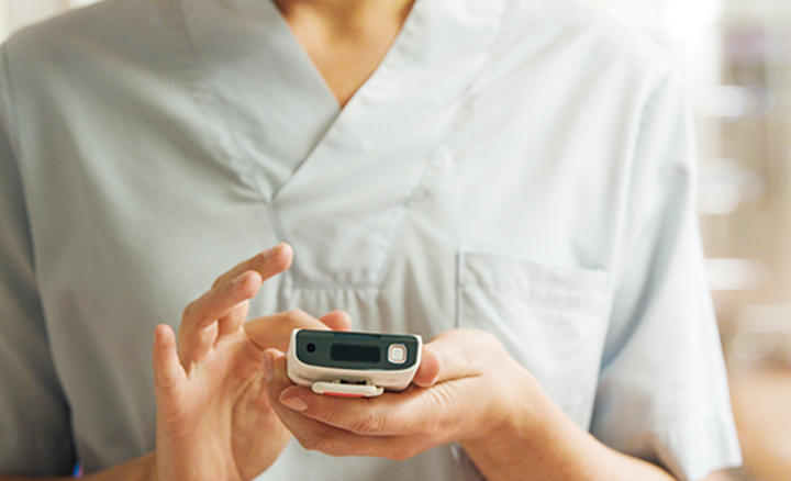 Detail of nurse hand holding and using a smart phone device