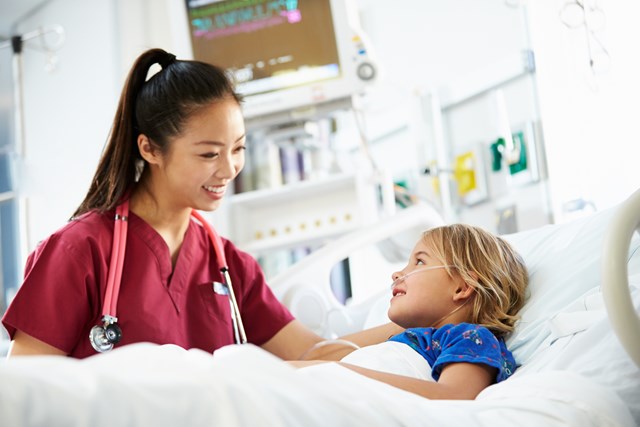 Close-up of boy patient and nurse looking at each other