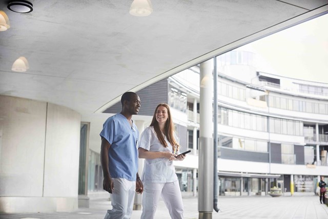 A male and female nurse walking down the street