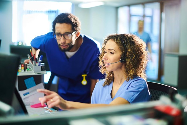 male and female clinicians looking at monitor