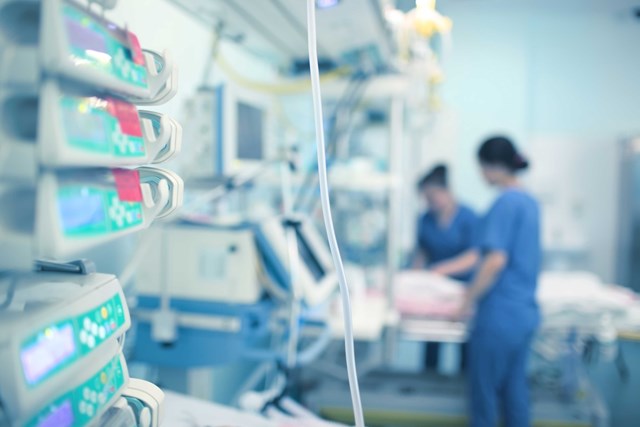 Blurred scene of a hospital room with clinicians